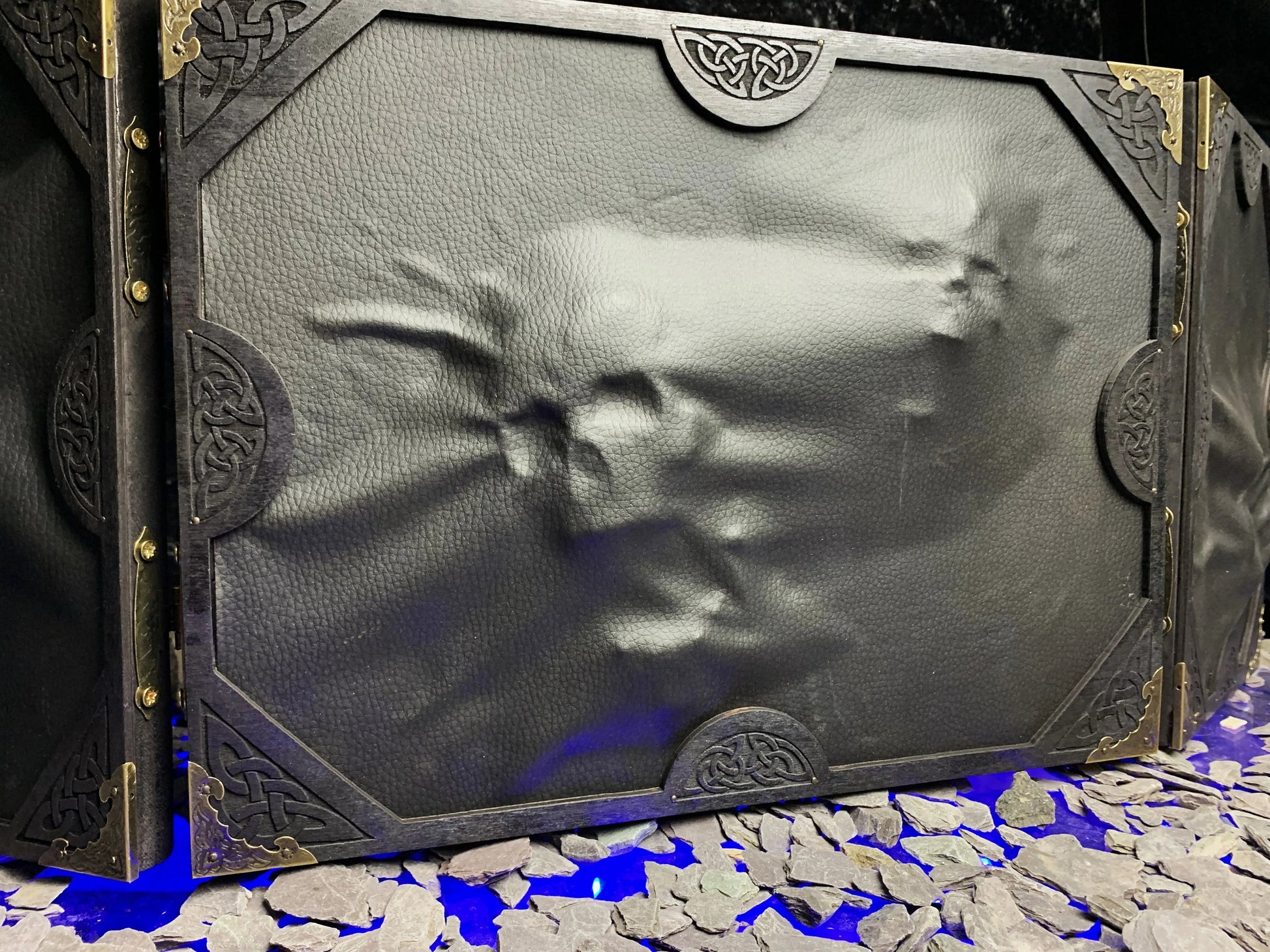 The Screen Of Trapped Souls Dungeon Master Screen  Beware the screen of trapped souls!  Made from solid wood with a black PU leather front; this screen is made to create atmosphere at your table. Complete with 3D skulls and hands protruding from the screen itself; stretching very planes of existence to escape!