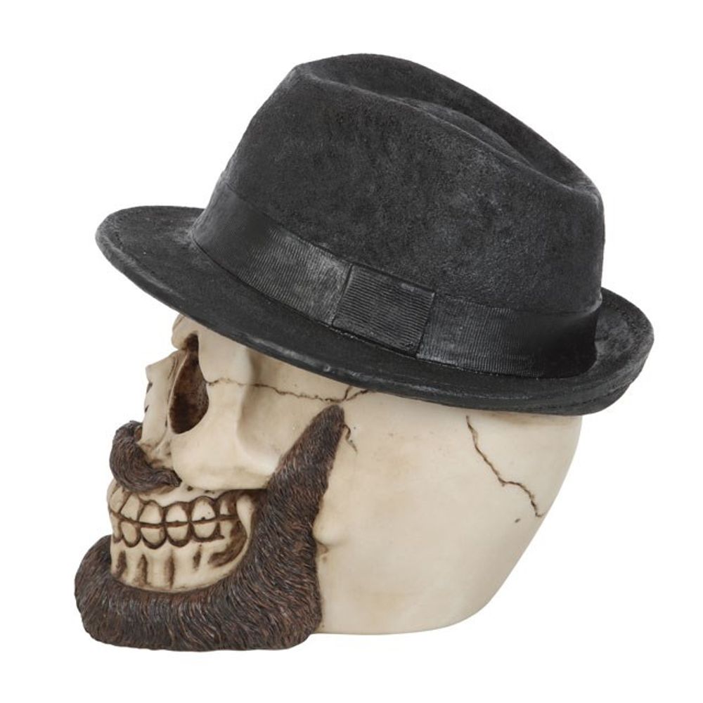 Skull Ornament with Trilby Hat This realistic resin skull ornament wears a classic trilby hat accented by an impressive beard and moustache. Highly detailed with hand painted details, this eye-catching figurine will be a welcome addition to any gothic skull collection. Free UK delivery by Fandomonium