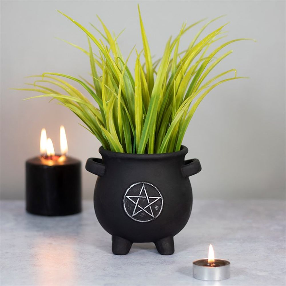 Pentagram Cauldron Plant Pot This black terracotta cauldron pot with silver pentagram design makes a unique and witch-approved way to grow plants and flowers in the home. This adoable plant pot is the perfect size for sunny windowsills and ledges. Can also be used to store pens and pencils on a gothic desk space. Free UK delivery by Fandomonium