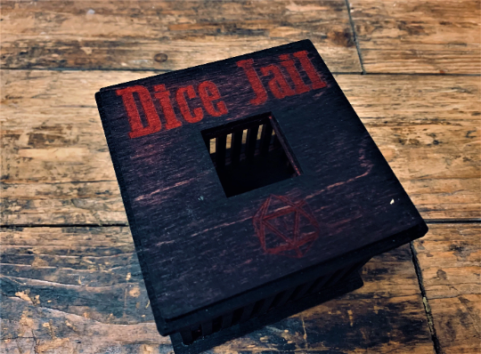 black wooden dice jail with colourful text. Choice of 3 colours. For use with Dungeons and Dragons, D&D, Tabletop Gaming. Dice games and RPG's. Free UK delivery with Fandomonium