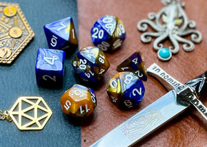 Elemental gold and black resin polyhedral dice set.  Unleash the fury of the fire elemental spirits with these fantastic resin dice. Combining gold and black swirls; each dice has its own unique pattern.