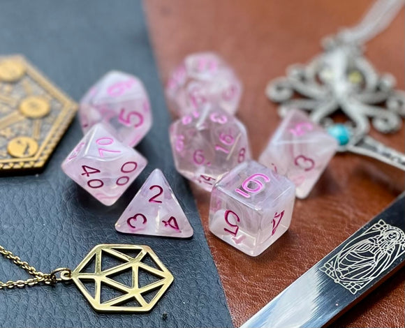 Elemental Gem Cloudy Passion Polyhedral Dice Set  Awaken the elements with these fantastic resin dice. Combining flawless crystal clear resin with white swirls; each dice has its own unique pattern.  They are standard 16mm polyhedral dice sets perfect for Tabletop games and RPG's such as pathfinder or dungeons and dragons.  This set includes one of each D20, D12, D10, D%, D8, D6, D4.