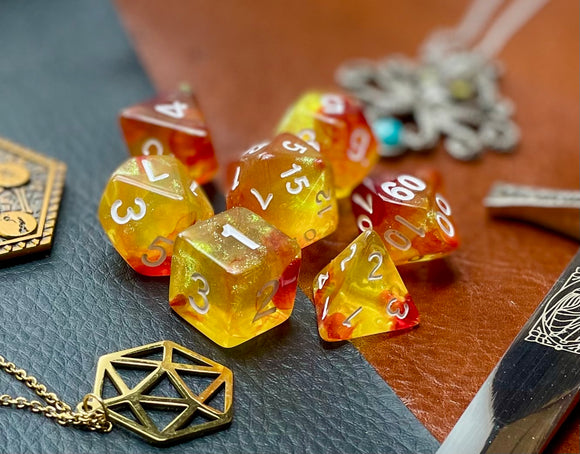 Elemental Gem Rising Phoenix Polyhedral Dice Set  Awaken the elements with these fantastic resin dice. Combining red and yellow translucent resin; each dice has its own unique pattern.  They are standard 16mm polyhedral dice sets perfect for Tabletop games and RPG's such as pathfinder or dungeons and dragons.  This set includes one of each D20, D12, D10, D%, D8, D6, D4.