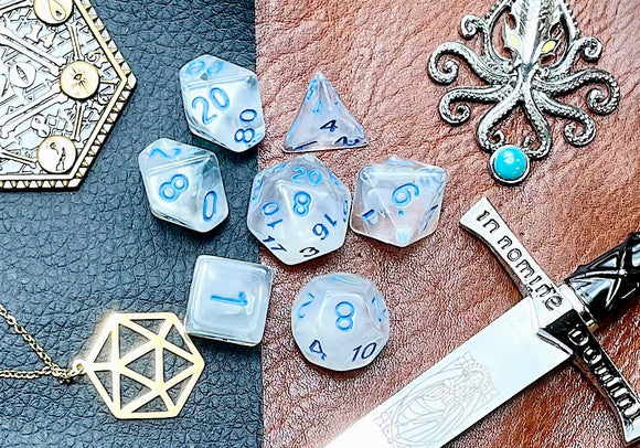 Elemental Gem Tireless Dancer Polyhedral Dice Set  Awaken the elements with these fantastic resin dice. Combining crystal clear resin with white swirls; each dice has its own unique pattern.  They are standard 16mm polyhedral dice sets perfect for Tabletop games and RPG's such as pathfinder or dungeons and dragons.  This set includes one of each D20, D12, D10, D%, D8, D6, D4.