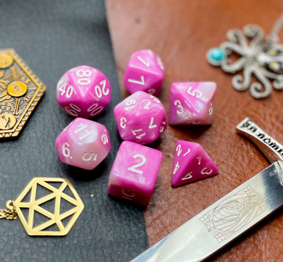 Elemental Magenta and White resin polyhedral dice set.  Awaken the elements with these fantastic resin dice. Combining vibrant magenta with white swirls; each dice has its own unique pattern.  They are standard 16mm polyhedral dice sets perfect for Tabletop games and RPG's such as pathfinder or dungeons and dragons.  This set includes one of each D20, D12, D10, D%, D8, D6, D4.
