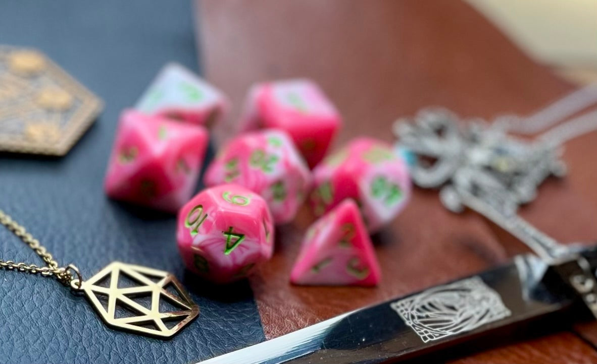 Elemental Pink and White resin polyhedral dice set.  Awaken the elements with these fantastic resin dice. Combining vibrant pink with white swirls; each dice has its own unique pattern.  They are standard 16mm polyhedral dice sets perfect for Tabletop games and RPG's such as pathfinder or dungeons and dragons.  This set includes one of each D20, D12, D10, D%, D8, D6, D4.