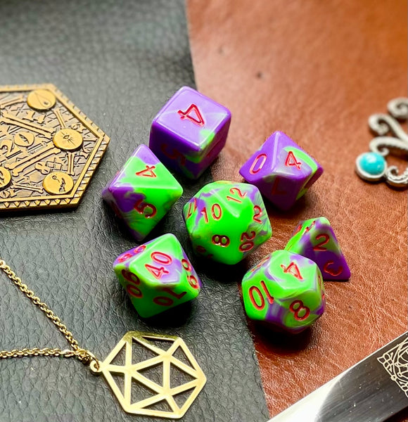 Elemental Purple and Green resin polyhedral dice set.  Awaken the elements with these fantastic resin dice. Combining vibrant pink with white swirls; each dice has its own unique pattern.  They are standard 16mm polyhedral dice sets perfect for Tabletop games and RPG's such as pathfinder or dungeons and dragons.  This set includes one of each D20, D12, D10, D%, D8, D6, D4.