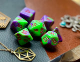 Elemental Purple and Green resin polyhedral dice set.  Awaken the elements with these fantastic resin dice. Combining vibrant pink with white swirls; each dice has its own unique pattern.  They are standard 16mm polyhedral dice sets perfect for Tabletop games and RPG's such as pathfinder or dungeons and dragons.  This set includes one of each D20, D12, D10, D%, D8, D6, D4.