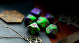 Elemental Purple and Green resin polyhedral dice set.  Awaken the elements with these fantastic resin dice. Combining vibrant pink with white swirls; each dice has its own unique pattern.  They are standard 16mm polyhedral dice sets perfect for Tabletop games and RPG's such as pathfinder or dungeons and dragons.  This set includes one of each D20, D12, D10, D%, D8, D6, D4.