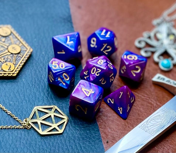 Elemental purple and blue resin polyhedral dice set.  Harness the power of the air and water elemental spirits with these fantastic resin dice. Combining blue and copper swirls, each dice has its own unique pattern.