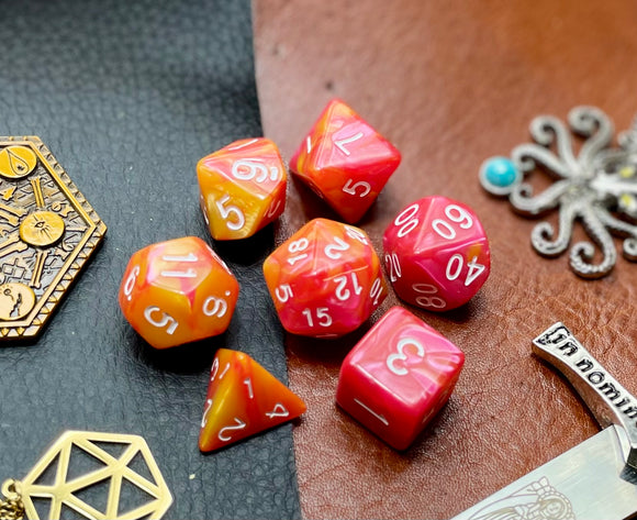 Elemental Rose and Orange resin polyhedral dice set.  Awaken the elements with these fantastic resin dice. Combining vibrant rose and orange swirls; each dice has its own unique pattern.  They are standard 16mm polyhedral dice sets perfect for Tabletop games and RPG's such as pathfinder or dungeons and dragons.  This set includes one of each D20, D12, D10, D%, D8, D6, D4.