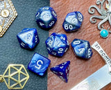 Elemental Steel and Blue resin polyhedral dice set.  Awaken the elements with these fantastic resin dice. Combining vibrant blue and steel swirls; each dice has its own unique pattern.  They are standard 16mm polyhedral dice sets perfect for Tabletop games and RPG's such as pathfinder or dungeons and dragons.  This set includes one of each D20, D12, D10, D%, D8, D6, D4.