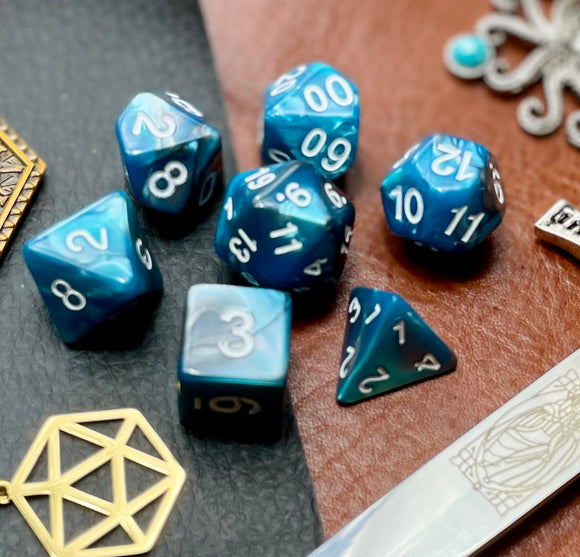 Elemental Steel and Teal resin polyhedral dice set.  Awaken the elements with these fantastic resin dice. Combining vibrant teal and steel swirls; each dice has its own unique pattern.  They are standard 16mm polyhedral dice sets perfect for Tabletop games and RPG's such as pathfinder or dungeons and dragons.  This set includes one of each D20, D12, D10, D%, D8, D6, D4.