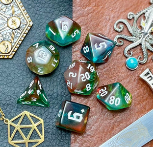 Elemental Gems of the Wind Elves resin polyhedral dice set.  Marvel at the sacred stones of the Wind Elves with these fantastic resin dice. Combining translucent green and blues; each dice has its own unique pattern.  They are standard 16mm polyhedral dice sets perfect for Tabletop games and RPG's such as pathfinder or dungeons and dragons.  This set includes one of each D20, D12, D10, D%, D8, D6, D4.