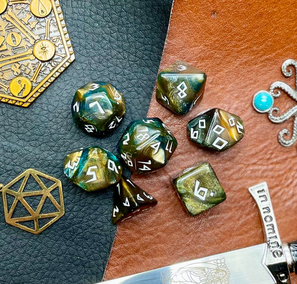 Galaxy Runic Polyhedral Dice Set  Traverse the galaxy with these unique dice. Combining gold, green and blue swirls with gold shimmer; each dice has its own unique pattern.  They are standard 16mm polyhedral dice sets perfect for Tabletop games and RPG's such as pathfinder or dungeons and dragons.  This set includes one of each D20, D12, D10, D%, D8, D6, D4.