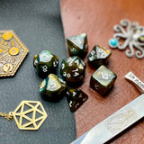 Galaxy Runic Polyhedral Dice Set  Traverse the galaxy with these unique dice. Combining gold, green and blue swirls with gold shimmer; each dice has its own unique pattern.  They are standard 16mm polyhedral dice sets perfect for Tabletop games and RPG's such as pathfinder or dungeons and dragons.  This set includes one of each D20, D12, D10, D%, D8, D6, D4.