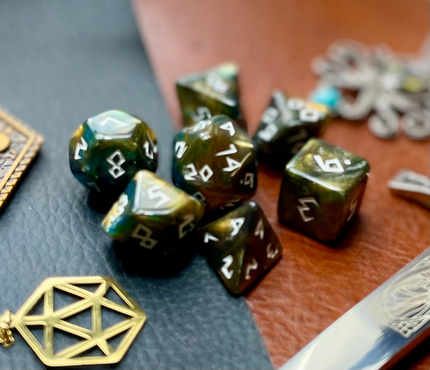 Galaxy Runic Polyhedral Dice Set  Traverse the galaxy with these unique dice. Combining gold, green and blue swirls with gold shimmer; each dice has its own unique pattern.  They are standard 16mm polyhedral dice sets perfect for Tabletop games and RPG's such as pathfinder or dungeons and dragons.  This set includes one of each D20, D12, D10, D%, D8, D6, D4.