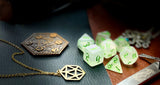 Glitter Shimmer With Green Font Polyhedral Dice Set  Traverse the galaxy with these unique dice. Combining frosted resin with shimmer and green font.  They are standard 16mm polyhedral dice sets perfect for Tabletop games and RPG's such as pathfinder or dungeons and dragons.  This set includes one of each D20, D12, D10, D%, D8, D6, D4.