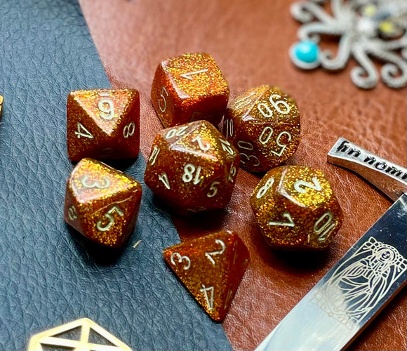 Gold Glitter Chessex Dice Set  These genuine Chessex polyhedral dice sets are a perfect addition to any dice collection.  They are standard 16mm polyhedral dice sets perfect for Tabletop games and RPG's such as pathfinder or dungeons and dragons.  This set includes one of each D20, D12, D10, D%, D8, D6, D4.  Why Choose Chessex?  Chessex are the market leaders in quality of dice and consistency of roll and have been creating dice for over 30 years