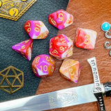 Pavlova Polyhedral Dice Set  Roll sweetly with these white, pink, orange and red marbled resin polyhedral dice set.  They are standard 16mm polyhedral dice sets perfect for Tabletop games and RPG's such as pathfinder or dungeons and dragons.  This set includes one of each D20, D12, D10, D%, D8, D6, D4.