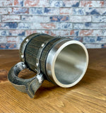 Medieval Viking Style Decorative Resin Drinking Tankard With Stainless Steel Insert.  Drink in style with our highly decorative tankard with wood effect panels, metal banding and rustic style handle. Holding 500ml you can drink with your clan in style. Perfect for decorating home bars, cosplay, tabletop gaming and all fans of Norse mythology, and medieval and fantasy decoration.