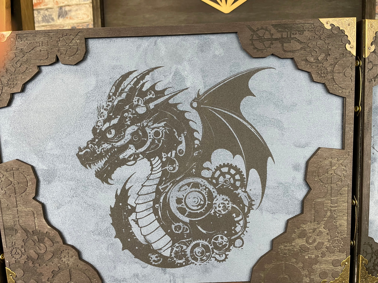 Draco Machina Dungeon Master Screen is a must-have for any tabletop gaming enthusiast. Crafted from high-quality wood and engraved with intricate designs, this screen is both sturdy and visually stunning. Ideal for tabletop gaming, Dungeons and Dragons, Pathfinder and many other TTRPG's