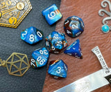 Elemental blue and copper resin polyhedral dice set.  Harness the power of the water and earth elemental spirits with these fantastic resin dice. Combining blue and copper swirls, each dice has its own unique pattern.  They are standard 16mm polyhedral dice sets perfect for Tabletop games and RPG's such as pathfinder or dungeons and dragons.