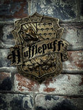 Discover the Wizarding World with this Officially Licensed bronze Harry Potter Hufflepuff Wall Plaque. Featuring a badger as the centre of this piece which is the emblematic animal of the Hufflepuff house, whose members are characterised by their cunning minds, ambition and pride. 