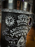 Spirit boards have long been one of the most powerful occult tools there is. Encompassing the black tankard is a spirit board design, decorated with white baroque detailing on the handle base and rim. In the centre the alphabet is marked out in an arc. Free UK Delivery by Fandomonium