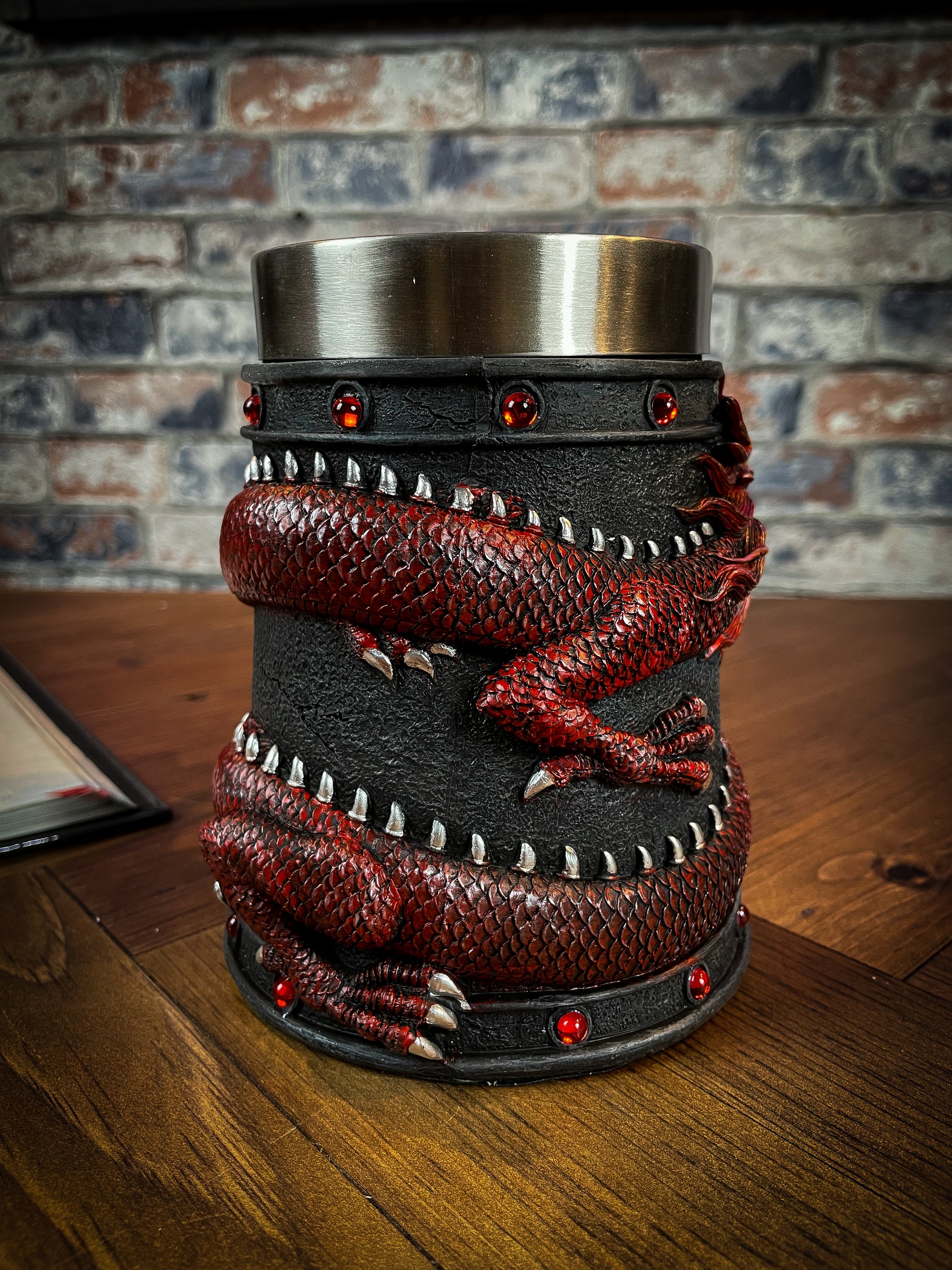 Drink deeply of a rich fantasy world with this enchanting Dragon Coil Tankard. Designed with a red onyx Dragon wrapped around the entirety of the tankard, jealously guarding the red jewels and your precious drink. Free UK Delivery from Fandomonium