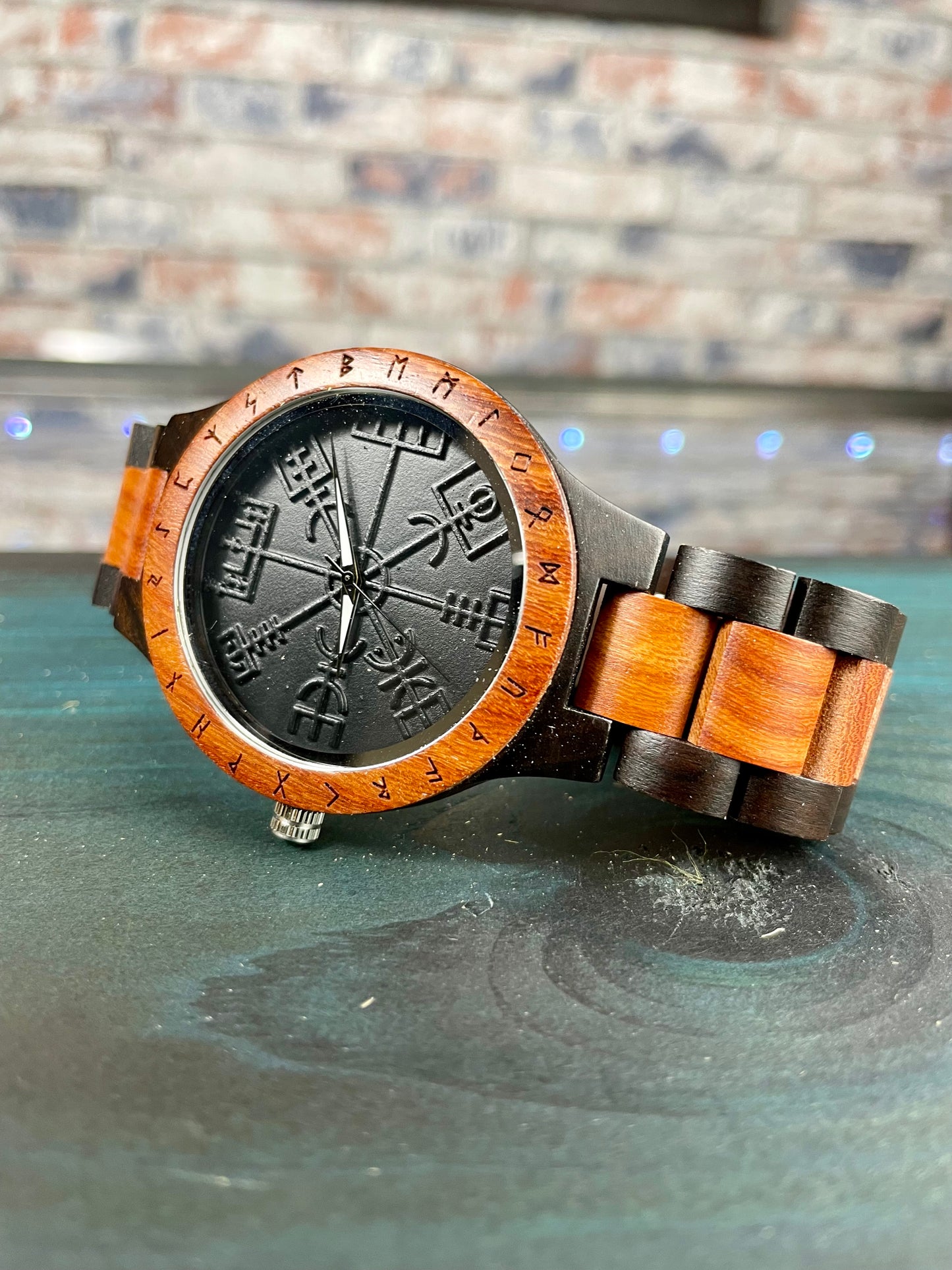 Wooden Norse Viking Design Watch. A unique style of watch with the strap, front and back of the watch all made from highly polished wood. Each time piece comes in a wooden display box and makes a perfect gift for fans of Norse Mythology and Viking Style. Complete with the Vegvisir Viking wayfinder on the watch face giving a unique and stylish look. Each watch also comes with a tool to help you add and remove links and a care &amp; instruction manual.