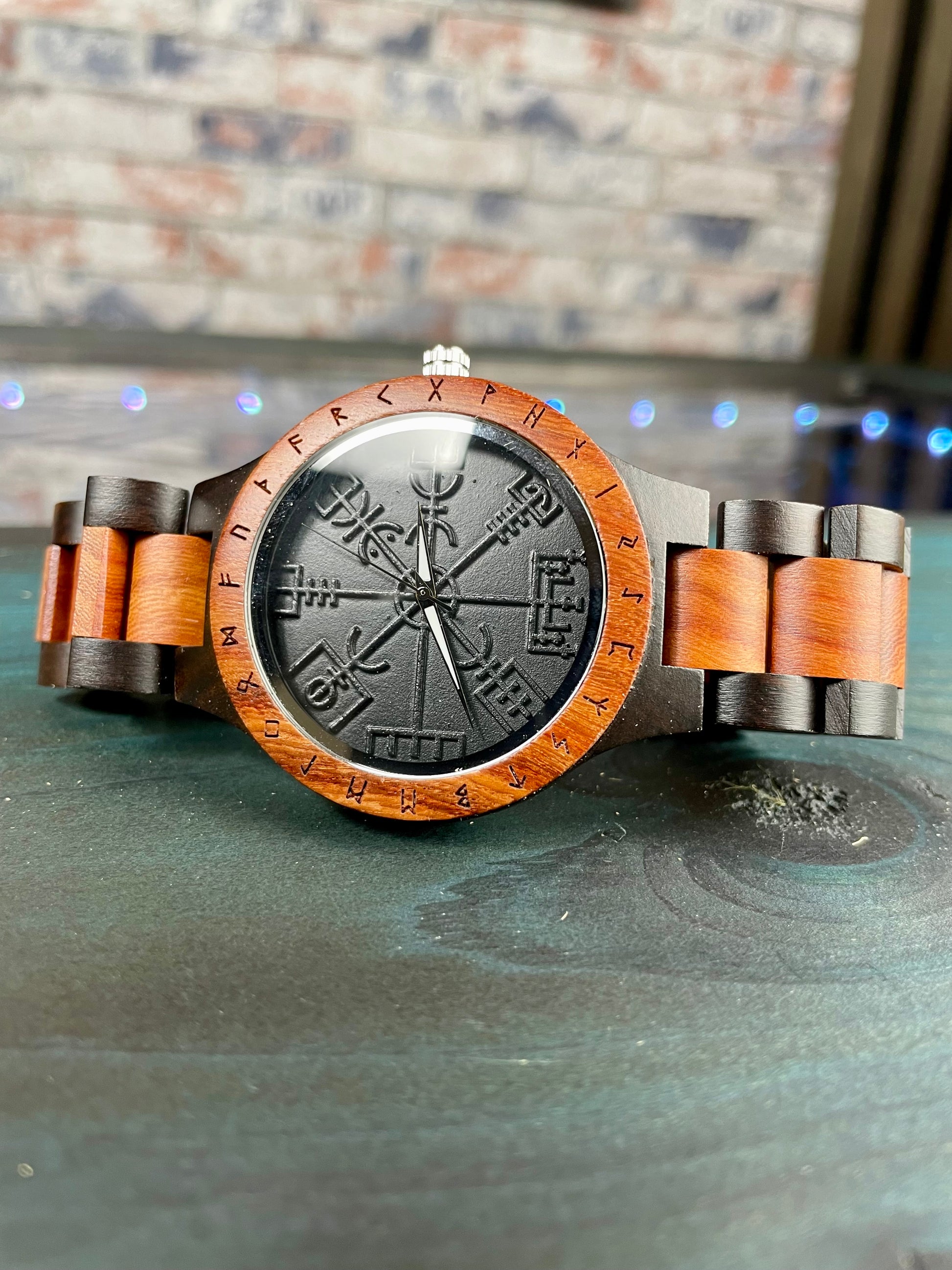 Wooden Norse Viking Design Watch. A unique style of watch with the strap, front and back of the watch all made from highly polished wood. Each time piece comes in a wooden display box and makes a perfect gift for fans of Norse Mythology and Viking Style. Complete with the Vegvisir Viking wayfinder on the watch face giving a unique and stylish look. Each watch also comes with a tool to help you add and remove links and a care &amp; instruction manual.