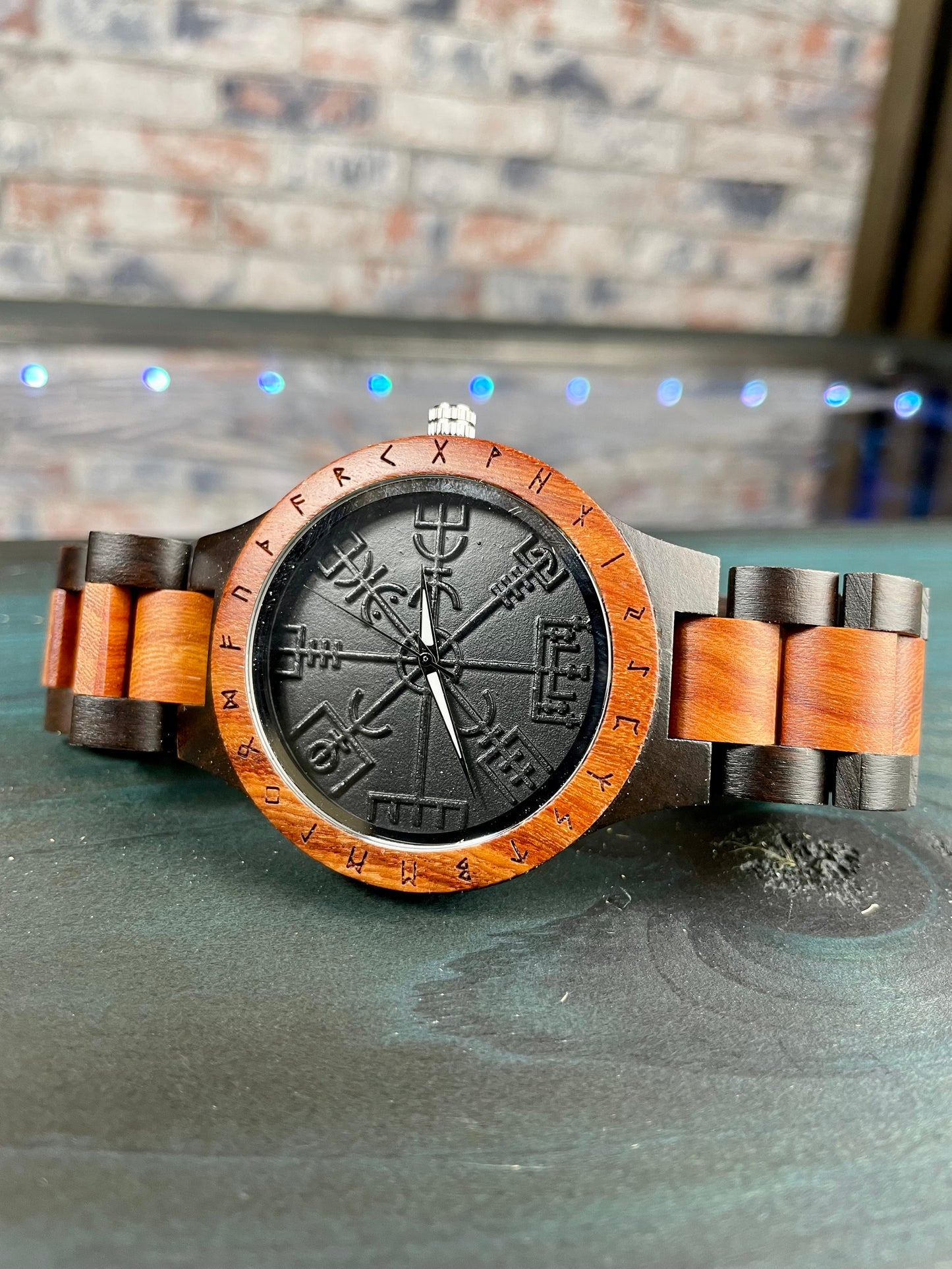 Wooden Norse Viking Design Watch. A unique style of watch with the strap, front and back of the watch all made from highly polished wood. Each time piece comes in a wooden display box and makes a perfect gift for fans of Norse Mythology and Viking Style. Complete with the Vegvisir Viking wayfinder on the watch face giving a unique and stylish look. Each watch also comes with a tool to help you add and remove links and a care &amp; instruction manual.