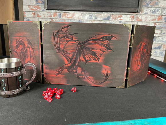 Fire Dragon DM Screen  Our brand new addition to our range of screens  Featuring our 3 fire dragons, the screen's 3 sections fold on hinges and has an antique effect catch for easy storage. Each screen is painted black before accenting the design in one of 4 vibrant colours; red, green, blue or purple. We embellish the DM screen with antiqued corner protectors to save you from bumps and scrapes. 