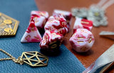 Red and White Marble Polyhedral Dice Set  Roll with style with these red and white marbled resin polyhedral dice set.  They are standard 16mm polyhedral dice sets perfect for Tabletop games and RPG's such as pathfinder or dungeons and dragons.  This set includes one of each D20, D12, D10, D%, D8, D6, D4.