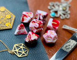 Red and White Marble Polyhedral Dice Set  Roll with style with these red and white marbled resin polyhedral dice set.  They are standard 16mm polyhedral dice sets perfect for Tabletop games and RPG's such as pathfinder or dungeons and dragons.  This set includes one of each D20, D12, D10, D%, D8, D6, D4.