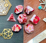 Red and White Marble Polyhedral Dice Set  Roll with style with these red and white marbled resin polyhedral dice set.  They are standard 16mm polyhedral dice sets perfect for Tabletop games and RPG's such as pathfinder or dungeons and dragons.  This set includes one of each D20, D12, D10, D%, D8, D6, D4.