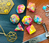 Rock Candy Polyhedral Dice Set  Roll sweetly with these pink, blue and yellow marbled resin polyhedral dice set.  They are standard 16mm polyhedral dice sets perfect for Tabletop games and RPG's such as pathfinder or dungeons and dragons.  This set includes one of each D20, D12, D10, D%, D8, D6, D4.