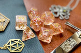 Ruby Glitter Flakes Polyhedral Dice Set  Traverse the galaxy with these unique dice. Combining crystal clear resin with ruby glitter flakes.  They are standard 16mm polyhedral dice sets perfect for Tabletop games and RPG's such as pathfinder or dungeons and dragons.  This set includes one of each D20, D12, D10, D%, D8, D6, D4.