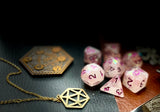 Glitter Shimmer With Pink Font Polyhedral Dice Set  Traverse the galaxy with these unique dice. Combining frosted resin with shimmer and pink font.  They are standard 16mm polyhedral dice sets perfect for Tabletop games and RPG's such as pathfinder or dungeons and dragons.  This set includes one of each D20, D12, D10, D%, D8, D6, D4.