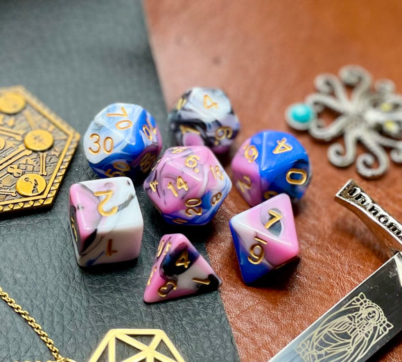 Snow Fey Polyhedral Dice Set  Enter the Fey Wilds with these blue, pink, black and white marbled resin polyhedral dice set.  They are standard 16mm polyhedral dice sets perfect for Tabletop games and RPG's such as pathfinder or dungeons and dragons.  This set includes one of each D20, D12, D10, D%, D8, D6, D4.