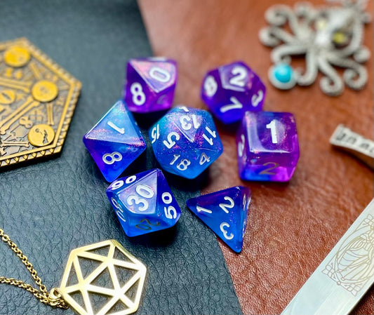 Sapphire Phantom Polyhedral Dice Sett  Enter the spirit realm blue and purple swirl resin polyhedral dice set.  They are standard 16mm polyhedral dice sets perfect for Tabletop games and RPG's such as pathfinder or dungeons and dragons.  This set includes one of each D20, D12, D10, D%, D8, D6, D4.