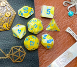 Yellow and White Marble Polyhedral Dice Set  Roll with style with these yellow and white marbled resin polyhedral dice set.  They are standard 16mm polyhedral dice sets perfect for Tabletop games and RPG's such as pathfinder or dungeons and dragons.  This set includes one of each D20, D12, D10, D%, D8, D6, D4.