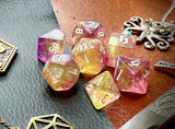 Chaos Fairy Polyhedral Dice Set  Roll to the gods with these pink and gold shimmer resin polyhedral dice set.  They are standard 16mm polyhedral dice sets perfect for Tabletop games and RPG's such as pathfinder or dungeons and dragons.  This set includes one of each D20, D12, D10, D%, D8, D6, D4.