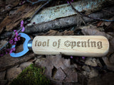 "Tool Of Opening" Wooden Bottle Opener  Engraved wooden handles bottle opener with "Tool of Opening" design. A perfect gift for any RPG or DND fan. Made from solid beech, stainless steel opener and engraved to order; these make a perfect quirky drinking gift.