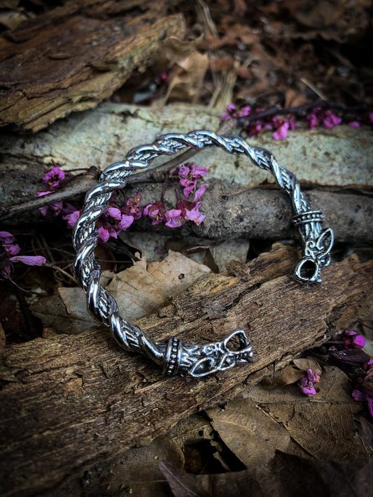 Viking style solid stainless steel bangle. Release your inner viking with this dragon head bangle with twist design. With a solid feel and detailed finish; these bangles a built for true modern day vikings.