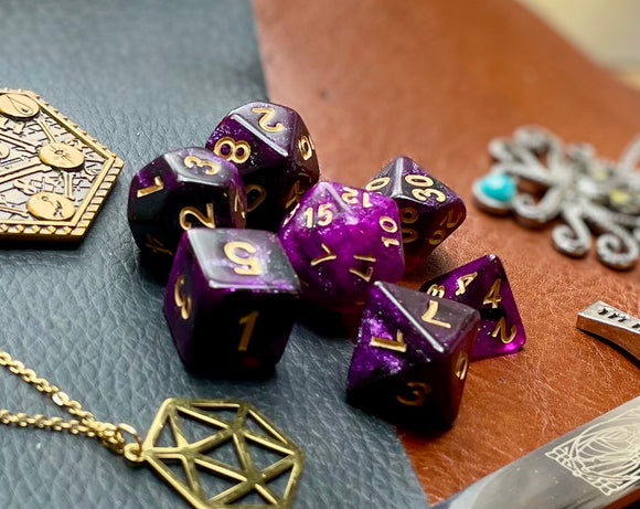 Purple Galaxy Polyhedral Dice Set  Travel the galaxy with these purple shimmer resin polyhedral dice sets are a perfect addition to any dice collection.  They are standard 16mm polyhedral dice sets perfect for Tabletop games and RPG's such as pathfinder or dungeons and dragons.  This set includes one of each D20, D12, D10, D%, D8, D6, D4.