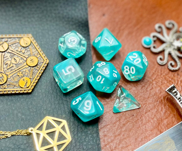 Teal Lake Polyhedral Dice Set  Peer into the lake on tranquility with these translucent teal and clear swirl resin polyhedral dice sets are a perfect addition to any dice collection.  They are standard 16mm polyhedral dice sets perfect for Tabletop games and RPG's such as pathfinder or dungeons and dragons.  This set includes one of each D20, D12, D10, D%, D8, D6, D4.