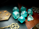 Teal Lake Polyhedral Dice Set  Peer into the lake on tranquility with these translucent teal and clear swirl resin polyhedral dice sets are a perfect addition to any dice collection.  They are standard 16mm polyhedral dice sets perfect for Tabletop games and RPG's such as pathfinder or dungeons and dragons.  This set includes one of each D20, D12, D10, D%, D8, D6, D4.