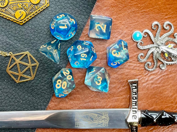 Under The Sea Polyhedral Dice Set  Dive the oceans with these translucent blue and clear swirl resin polyhedral dice sets are a perfect addition to any dice collection.  They are standard 16mm polyhedral dice sets perfect for Tabletop games and RPG's such as pathfinder or dungeons and dragons.  This set includes one of each D20, D12, D10, D%, D8, D6, D4.